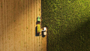 overview picture of a tractor harvesting crops on a farm
